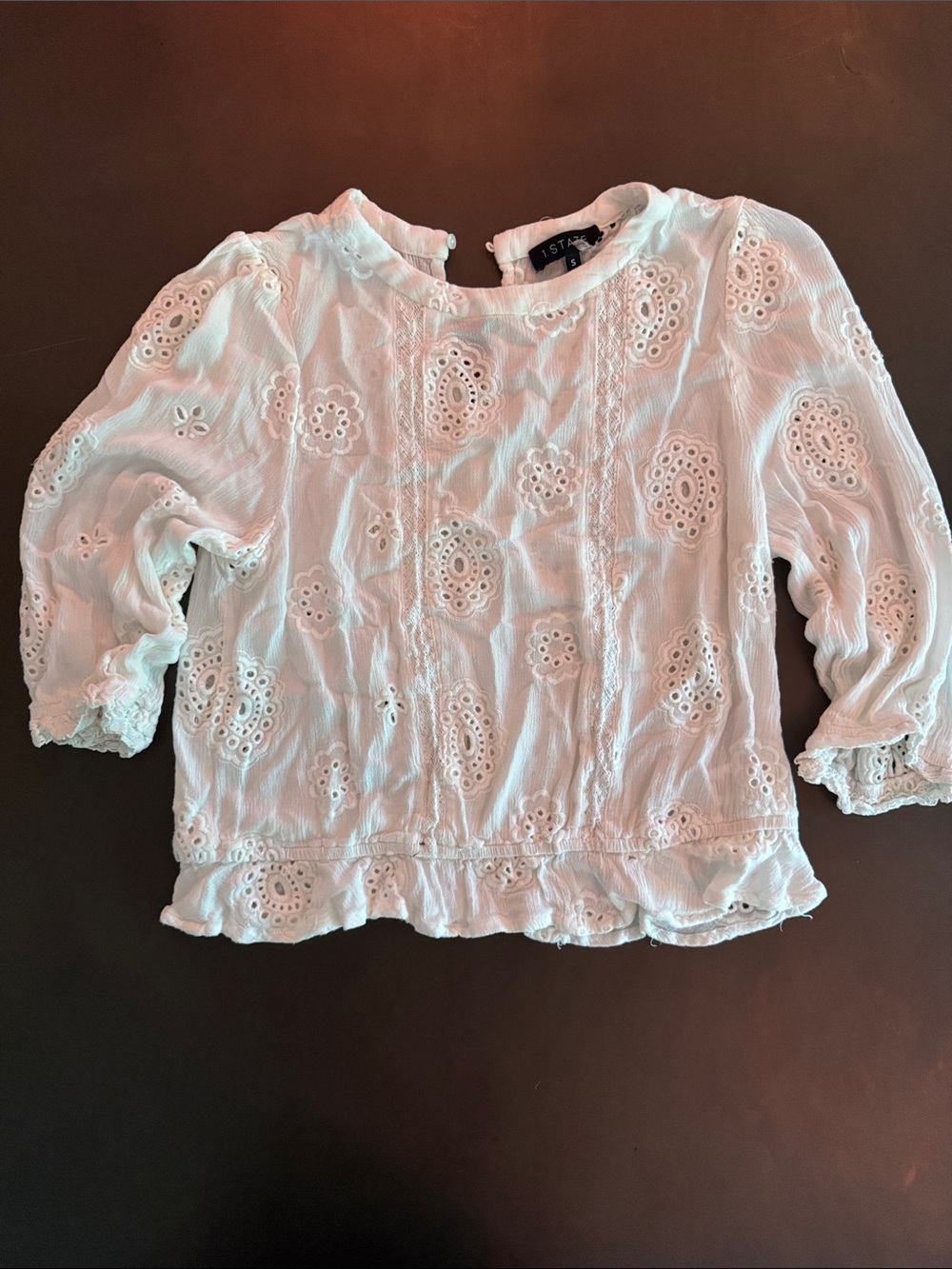 1. State White Eyelet Ruffled Hem Blouse